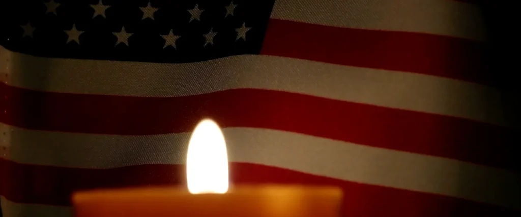 a candle with American flag on the background