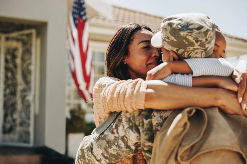 A veteran hugging his family