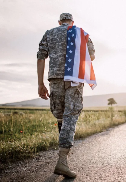 A Military Man Carrying the US Flag