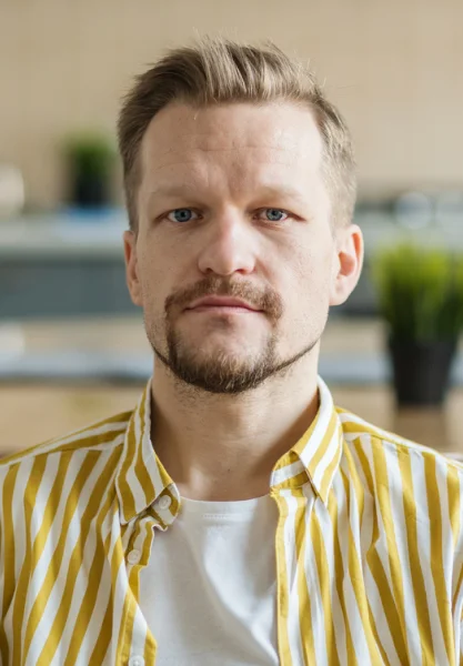 A Headshot of a person wearing yellow lined shirt