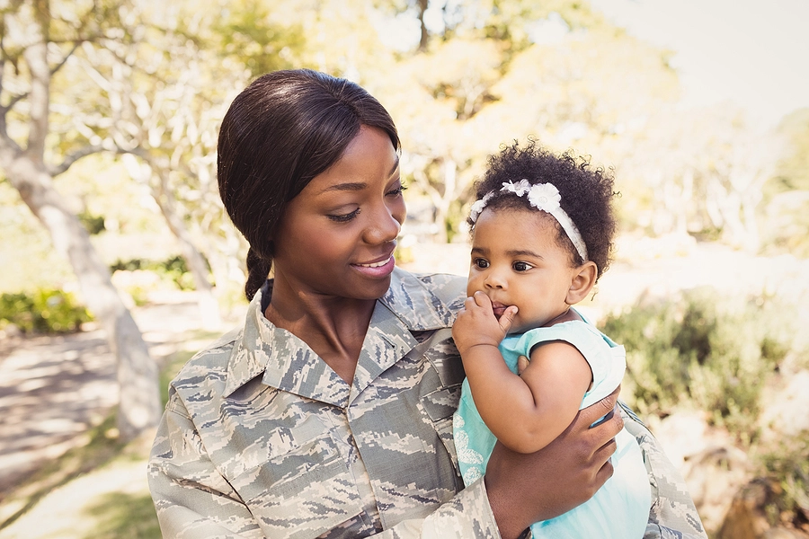 california veteran holding her infant daughter after being discharged with a service-related disability