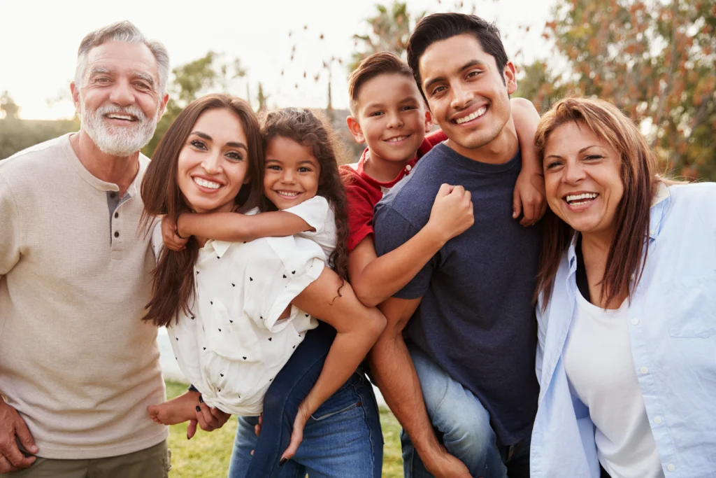 hispanic family pose for photo after reuniting through the immigration process - WHG